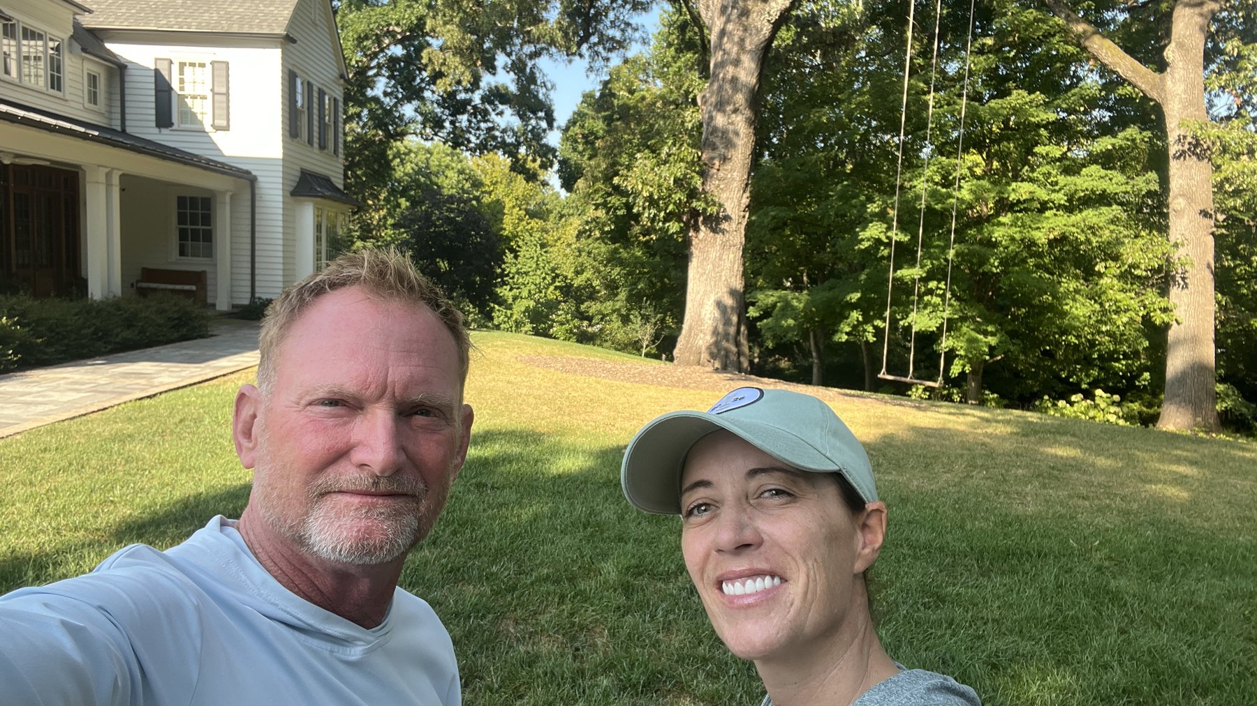 Chip Ward and Colette Murray standing together on a lawn in evening light